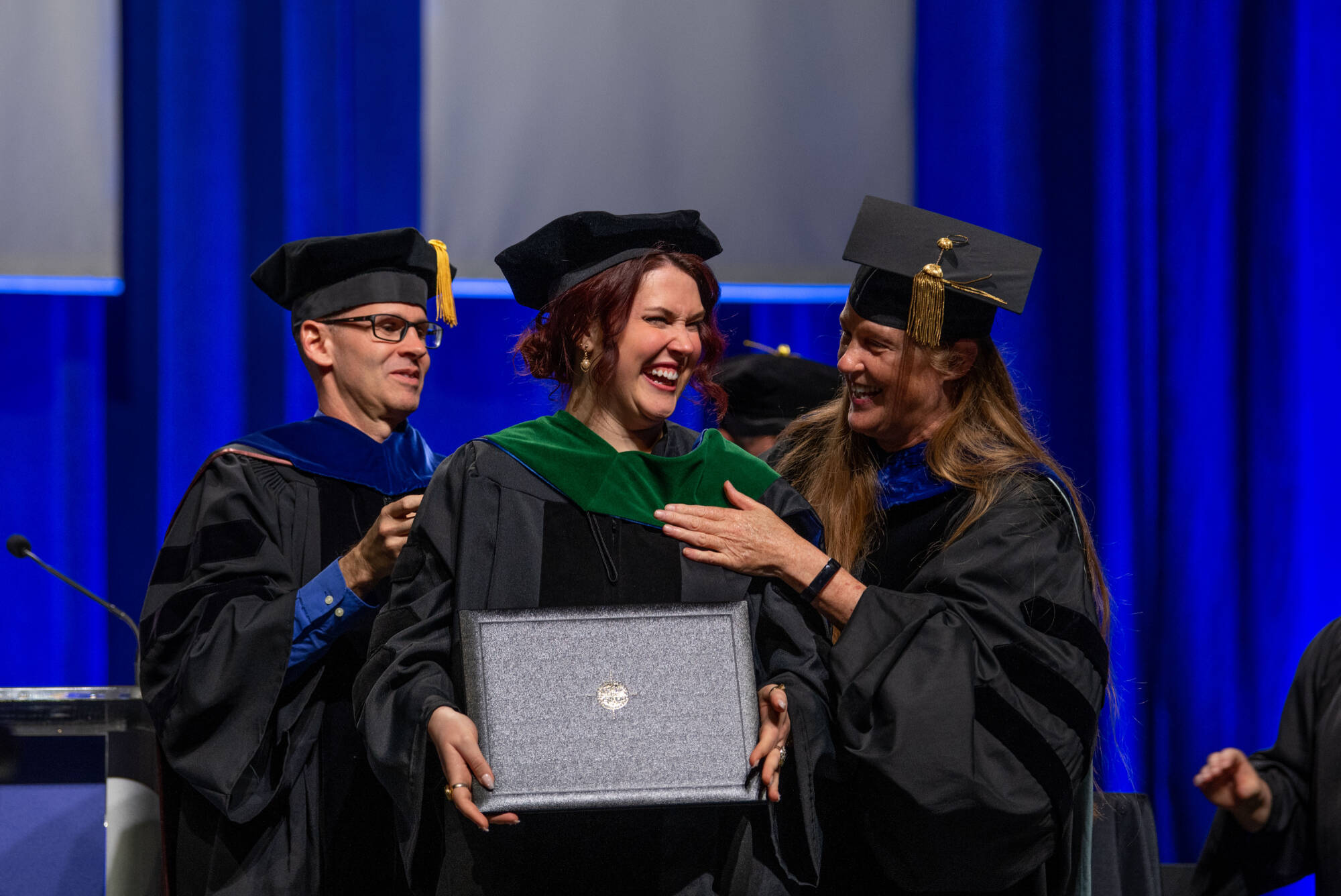 MastersStudentsSmilingandHugging.